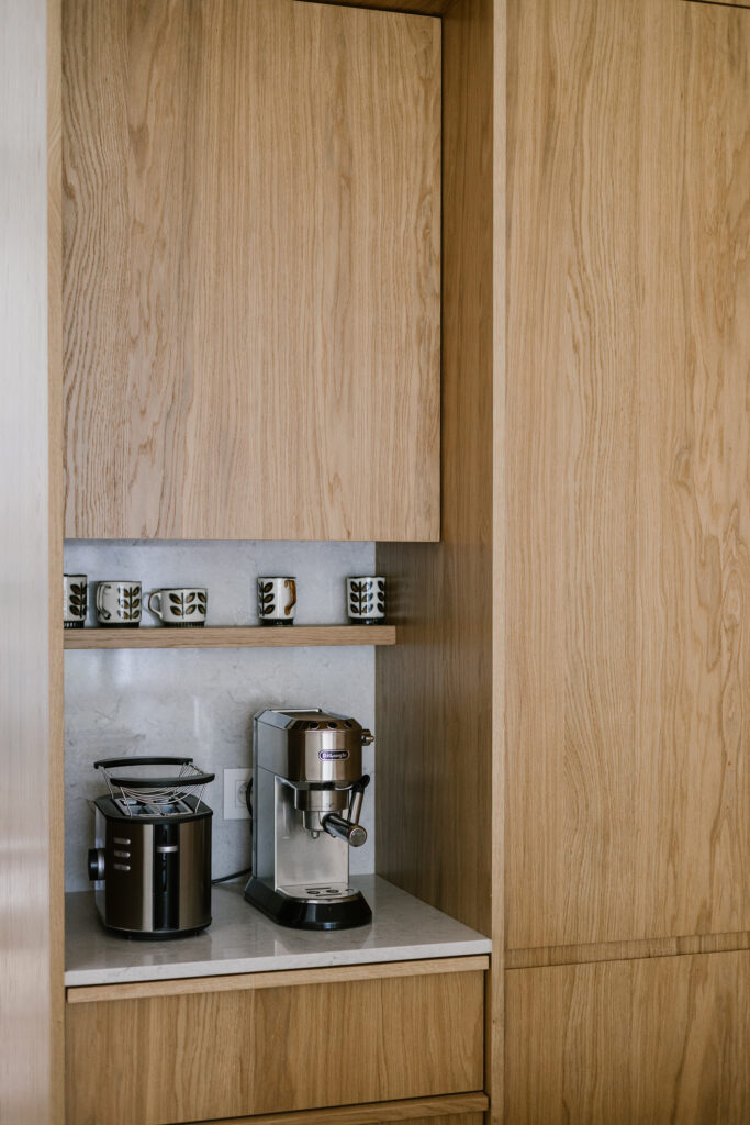 Bespoke oak kitchen cabinetry with integrated coffee station and open shelving