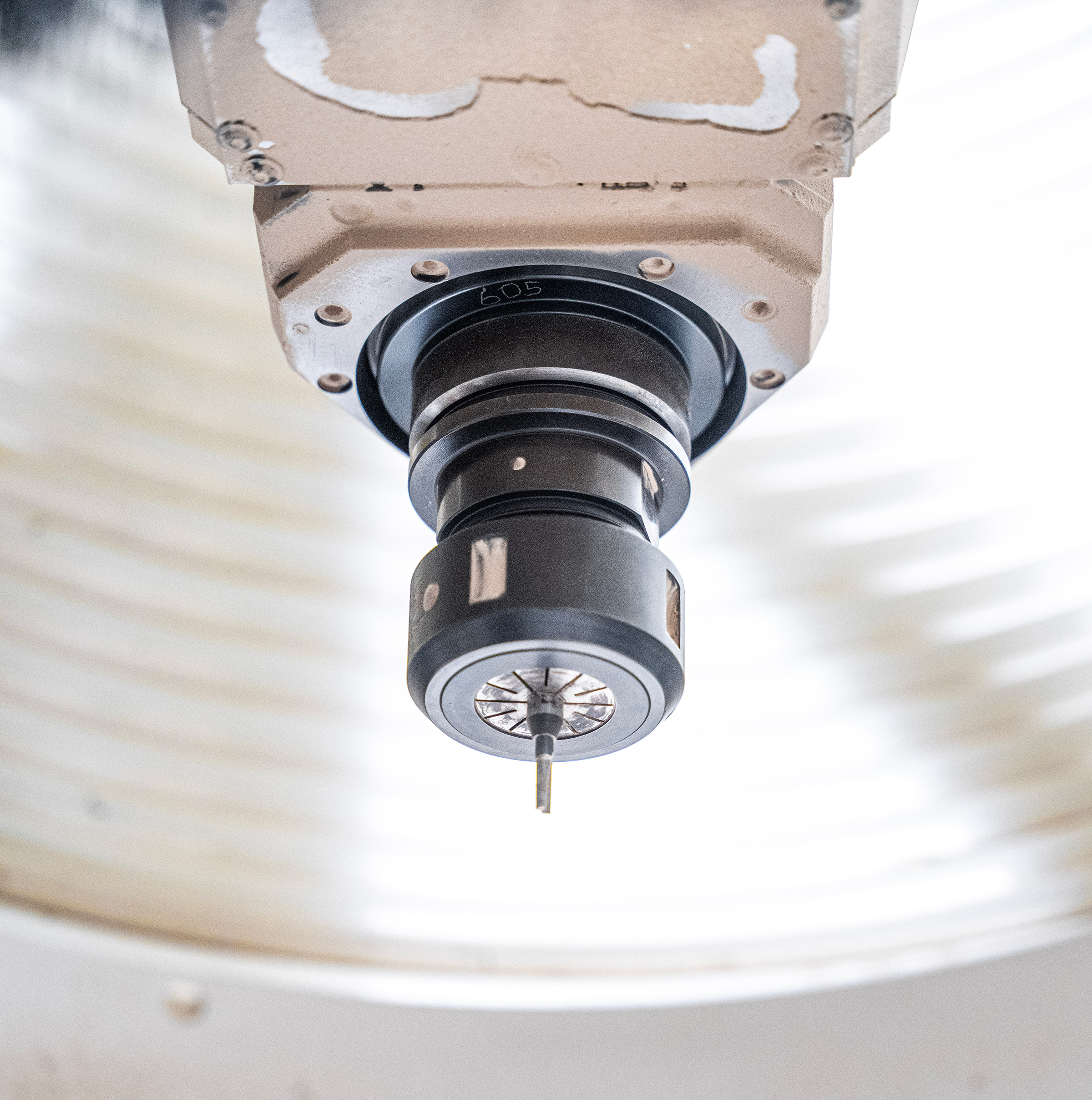 Close-up of a CNC milling spindle and cutting tool used for precision woodworking